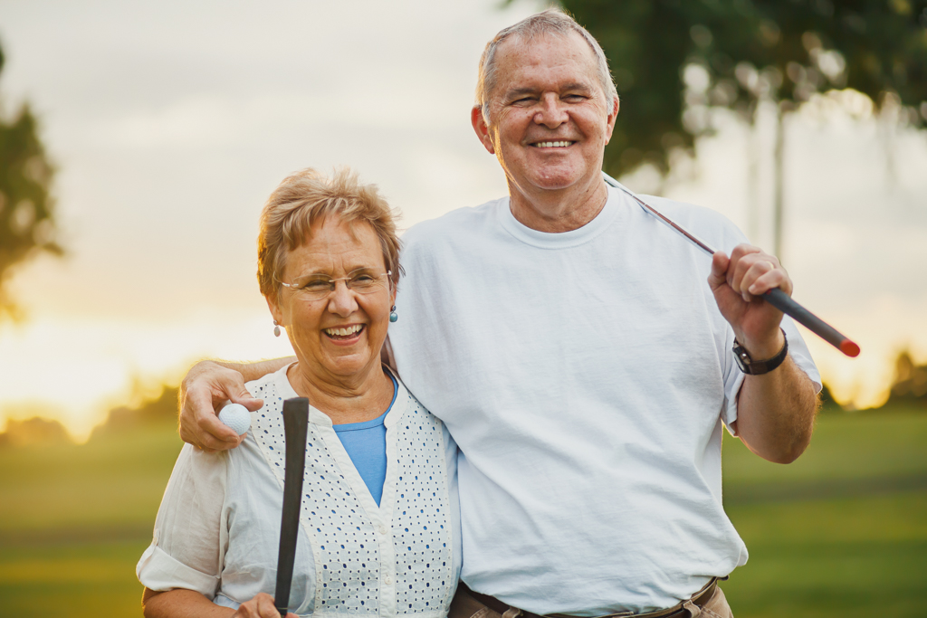 portrait of happy senior couple enjoying active lifestyle playing golf